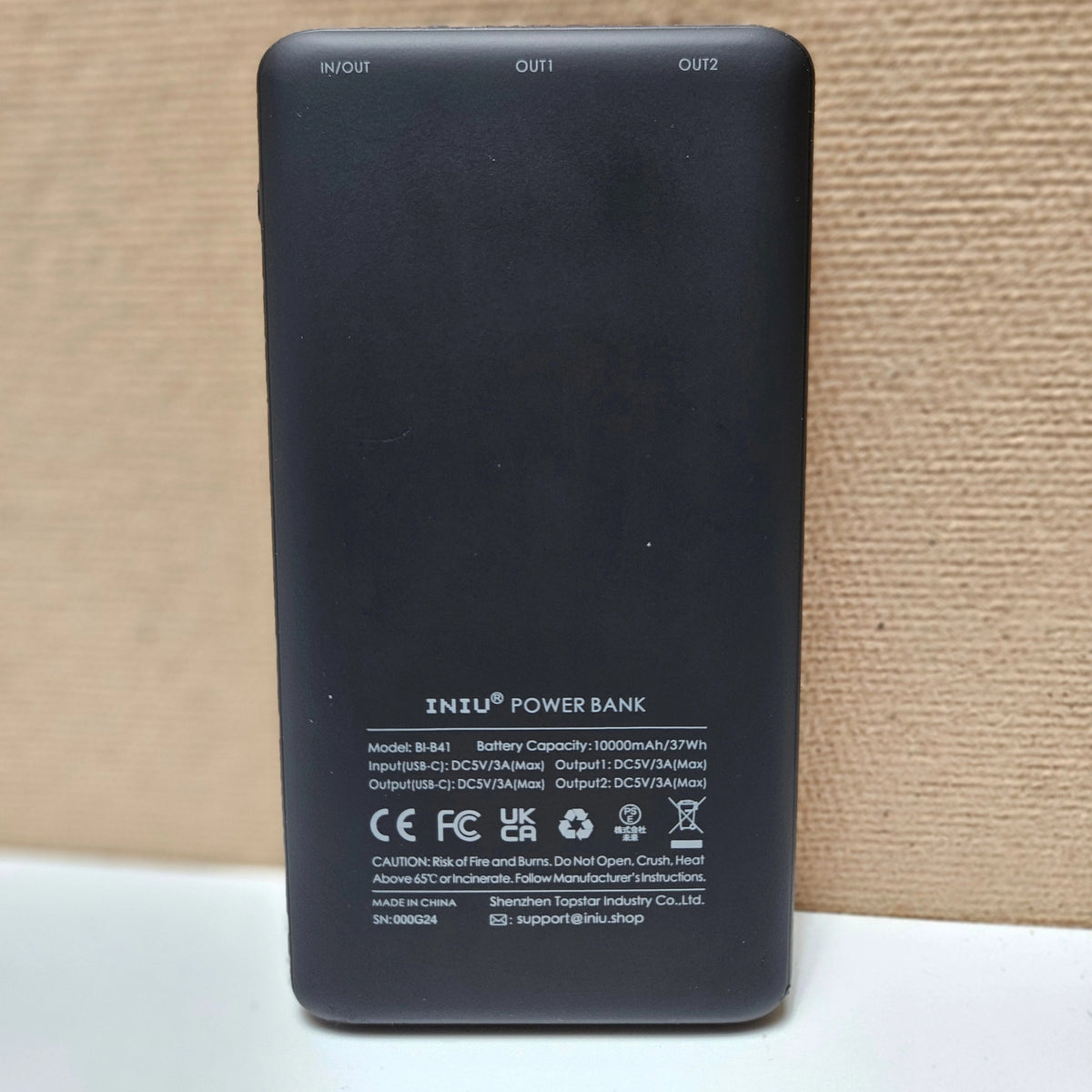 Technical specs and battery capacity on back of INIU charger.