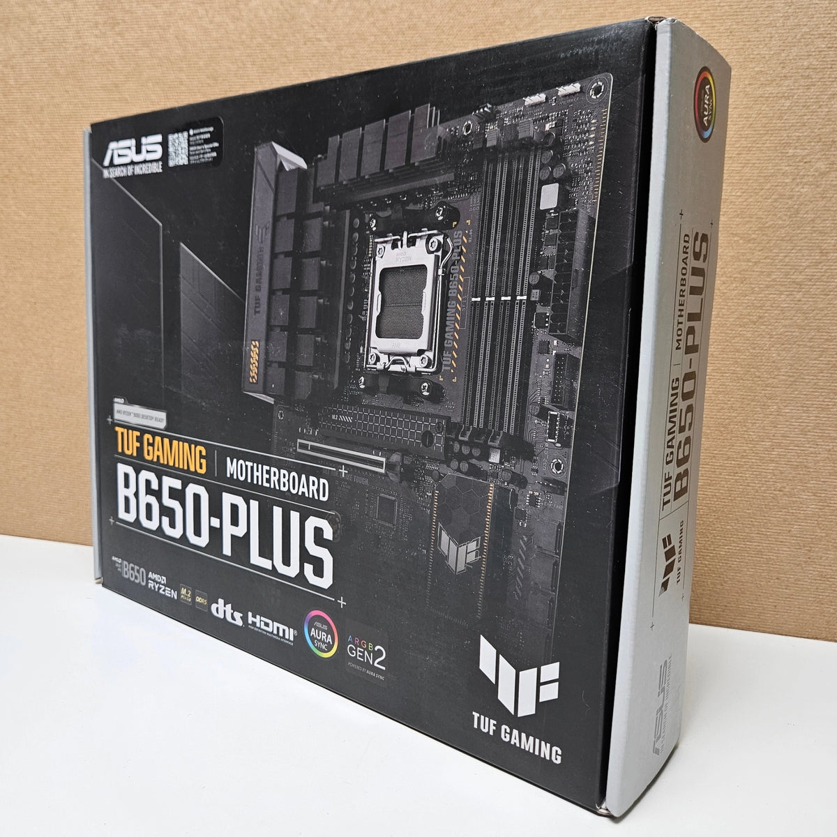 Front view of the ASUS TUF Gaming B650-PLUS motherboard retail packaging