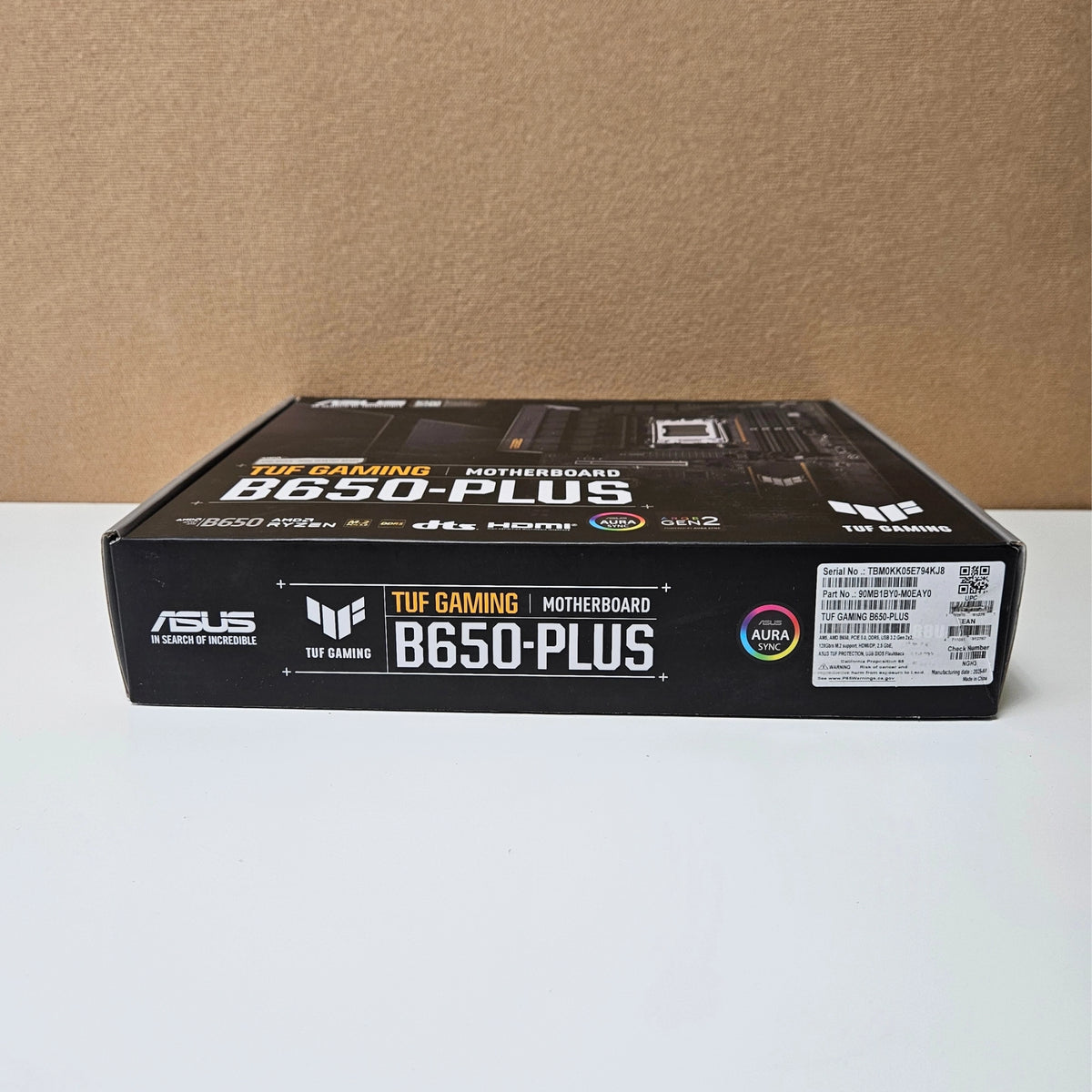 Side profile view of the retail box for the ASUS TUF Gaming B650-PLUS