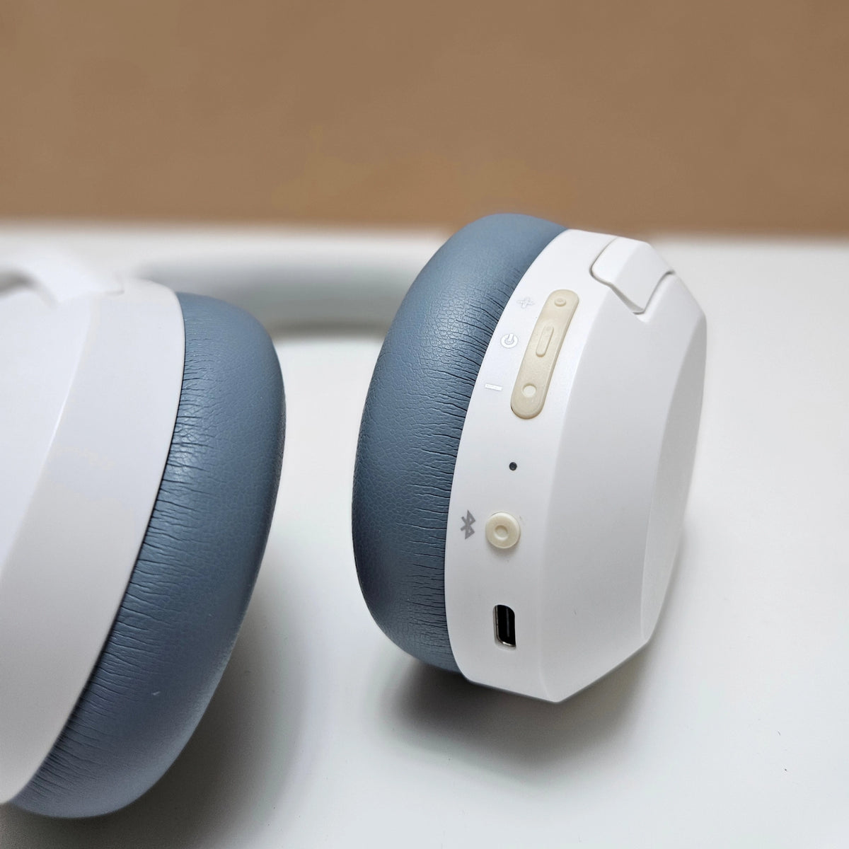Close-up of physical control buttons and USB-C port on the Edifier headphone earcup.