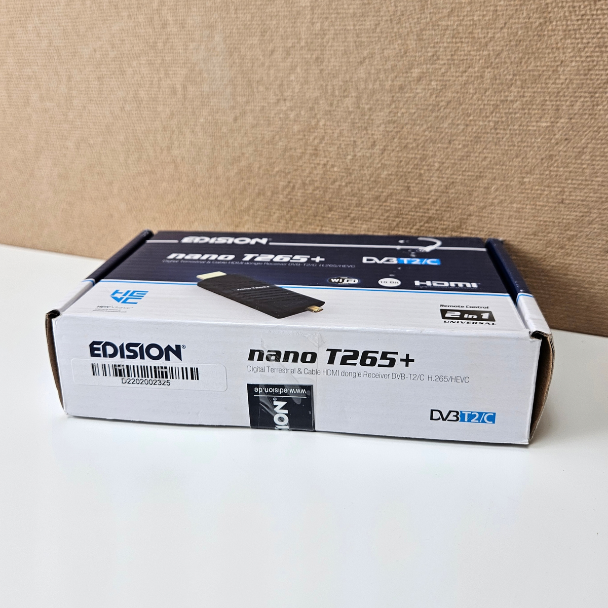 Edison nano T265+ HDMI receiver retail box on a white surface against a beige textured background.