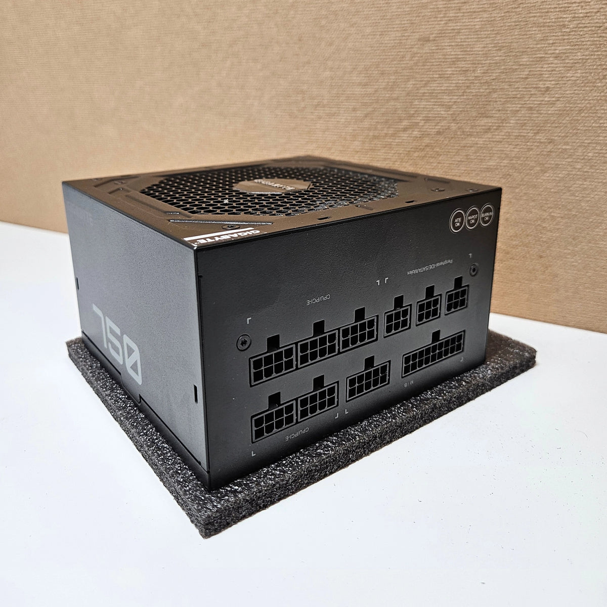 Close-up of the fully modular cable interface ports on a black Gigabyte P750GM power supply