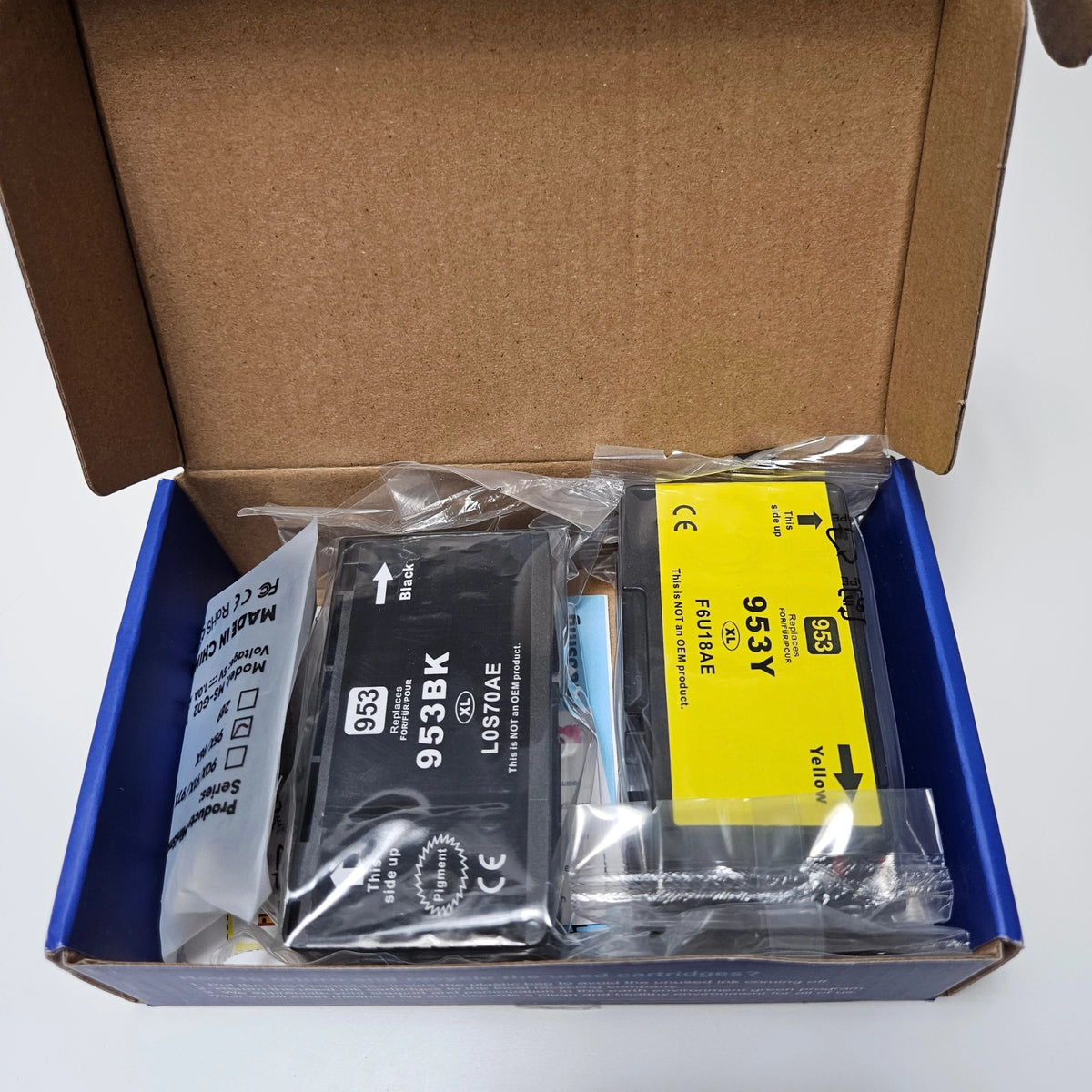 Opened cardboard box displaying wrapped black and yellow Skydo 953XL ink cartridges.