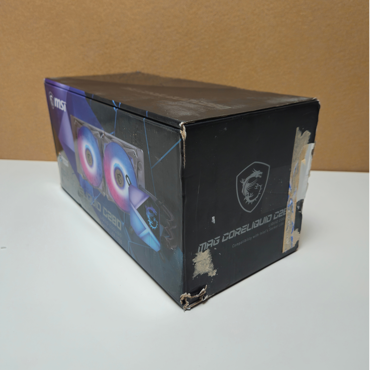 MSI Coreliquld RGB  liquid cooling tower product box, showing the front and side panels with graphics of dual RGB fans and the MSI dragon logo.