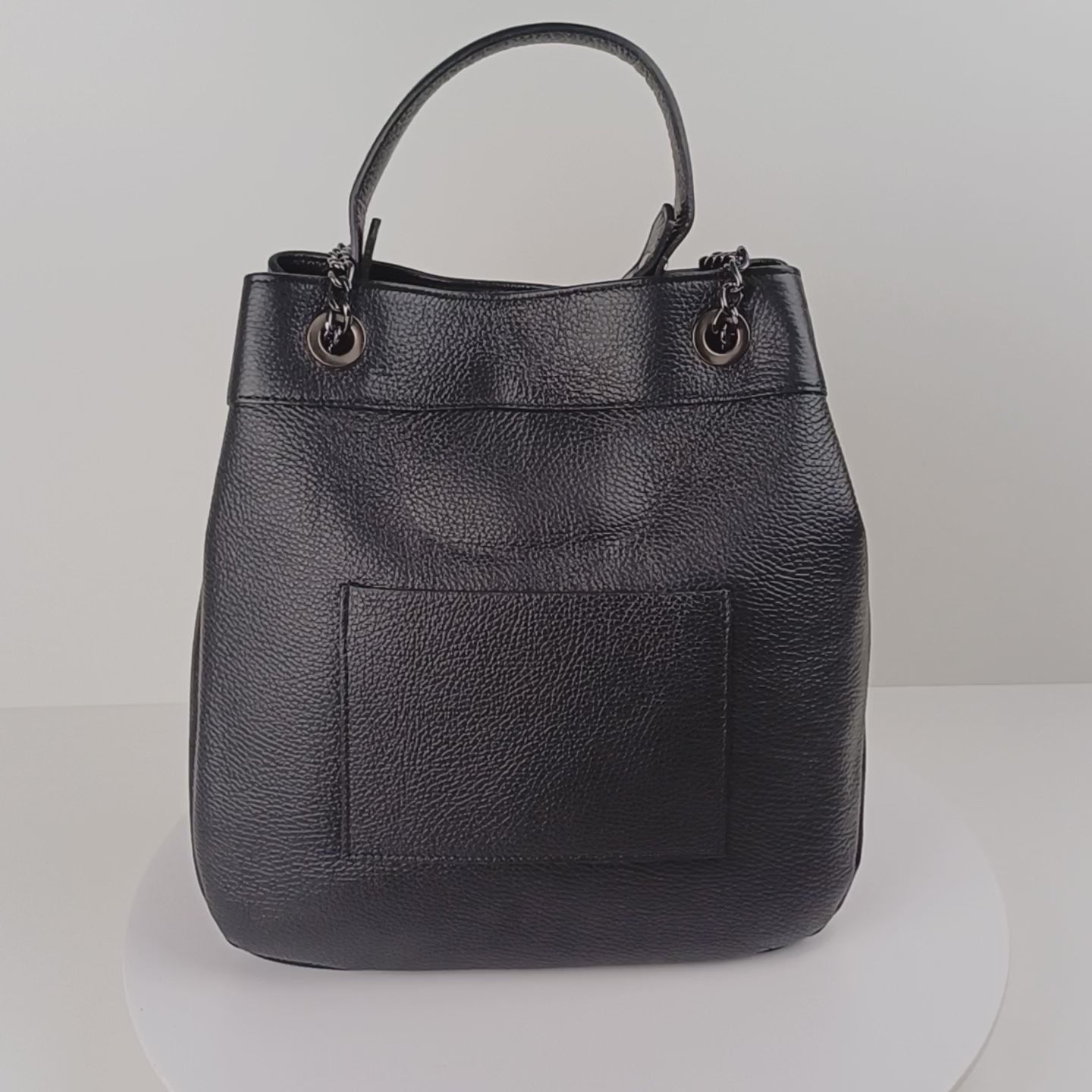 Video of black leather handbag with multiple carrying options: dual chain shoulder straps