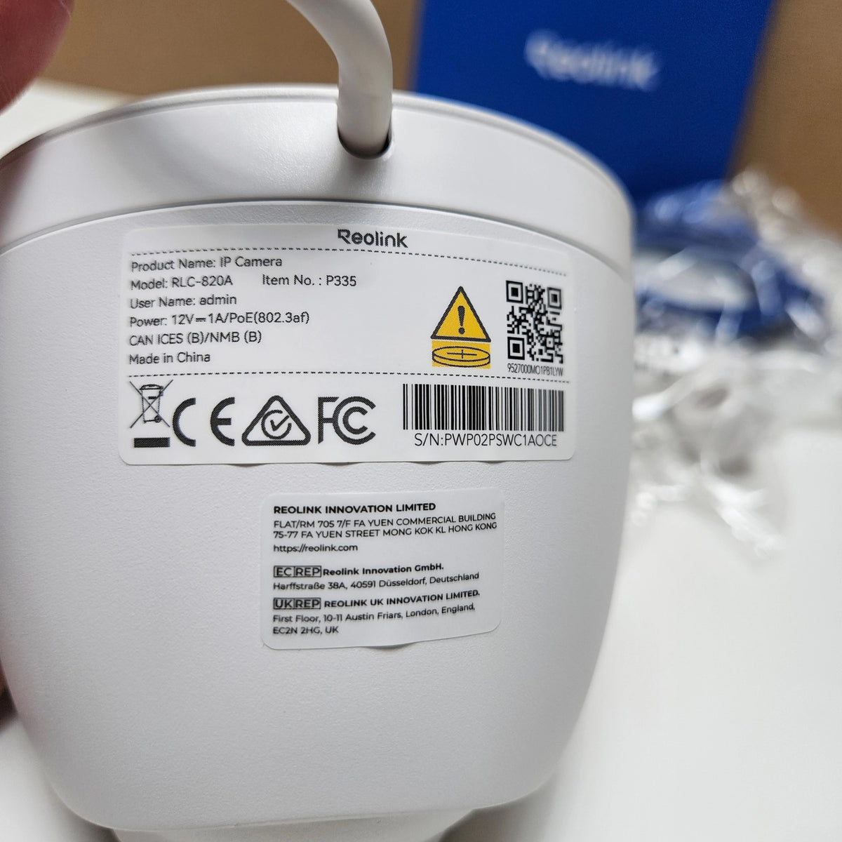 Close-up of the technical information sticker on the side of the Reolink dome camera body.