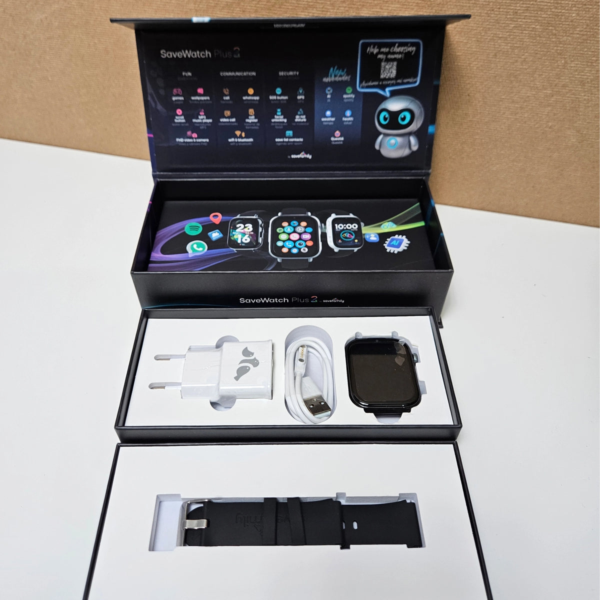 Unboxed SaveFamily SaveWatch Plus 2 with charger, cable, and black strap