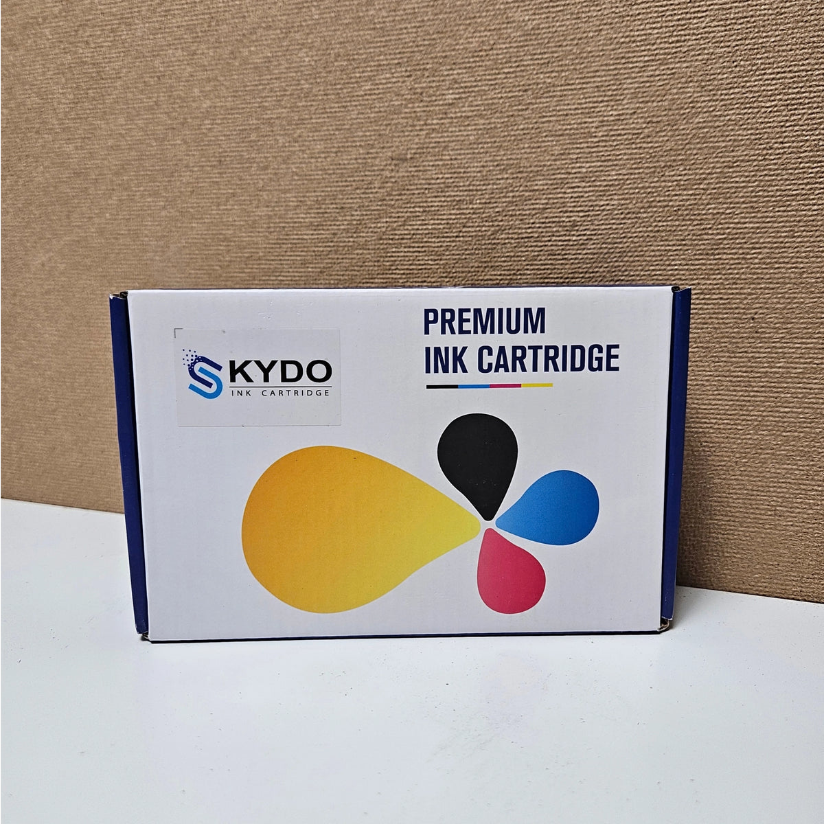 Front view of a white and blue Skydo premium ink cartridge box with a color drop logo