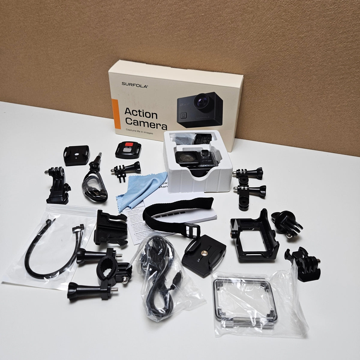 Complete Surfola SF230 bundle including camera, mounts, straps, cables, and manual. 